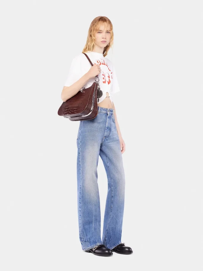 Utställda jeans prydda med 1969-skivor